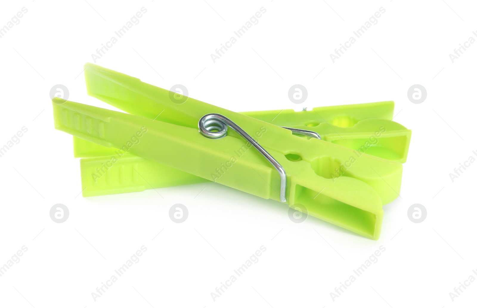 Photo of Bright green plastic clothespins on white background