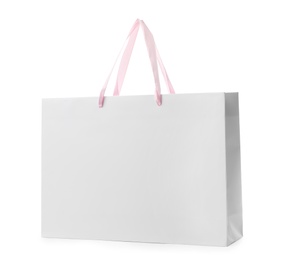 Photo of Paper shopping bag with handles on white background. Mockup for design