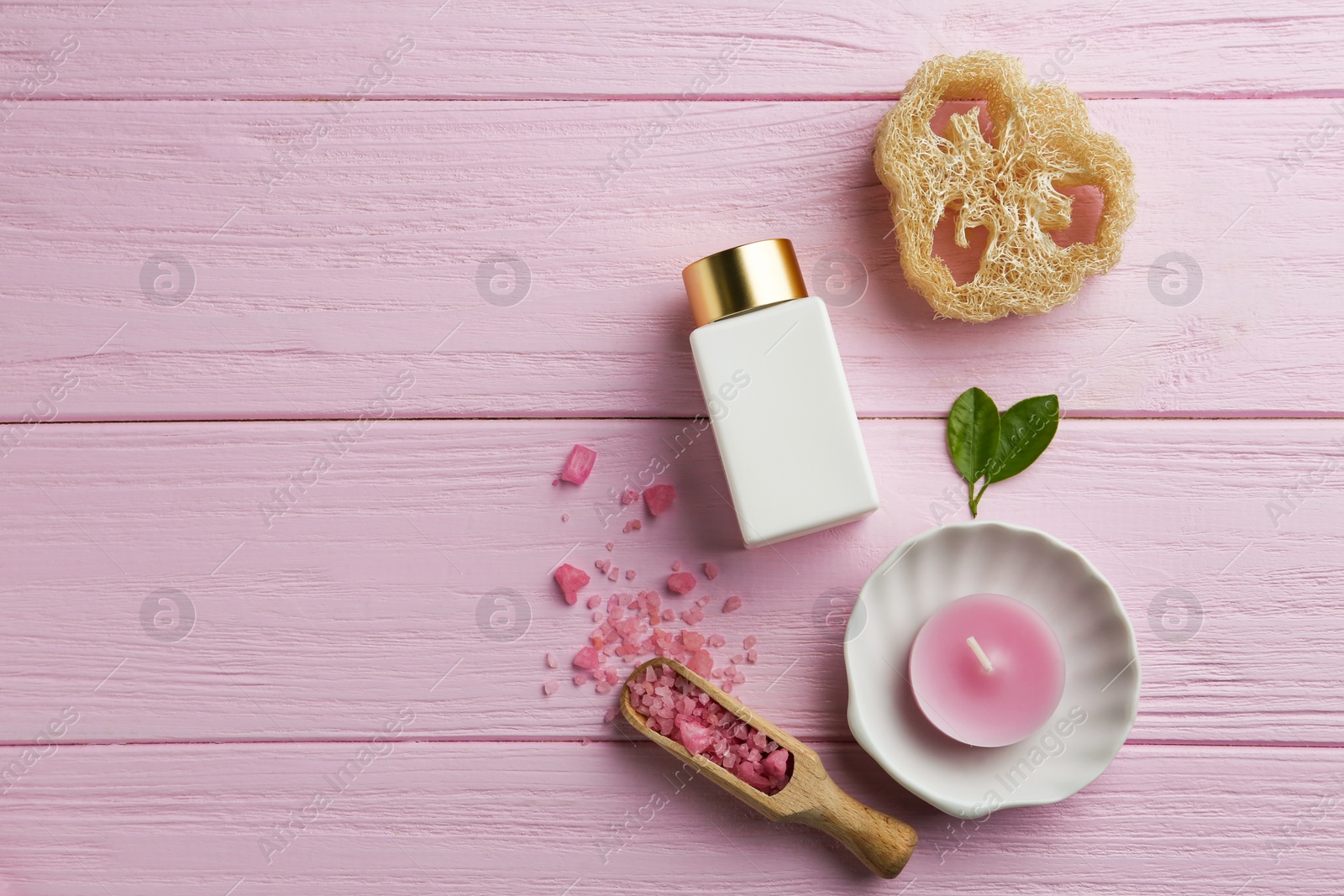 Photo of Flat lay composition with spa supplies on pink wooden table. Space for text