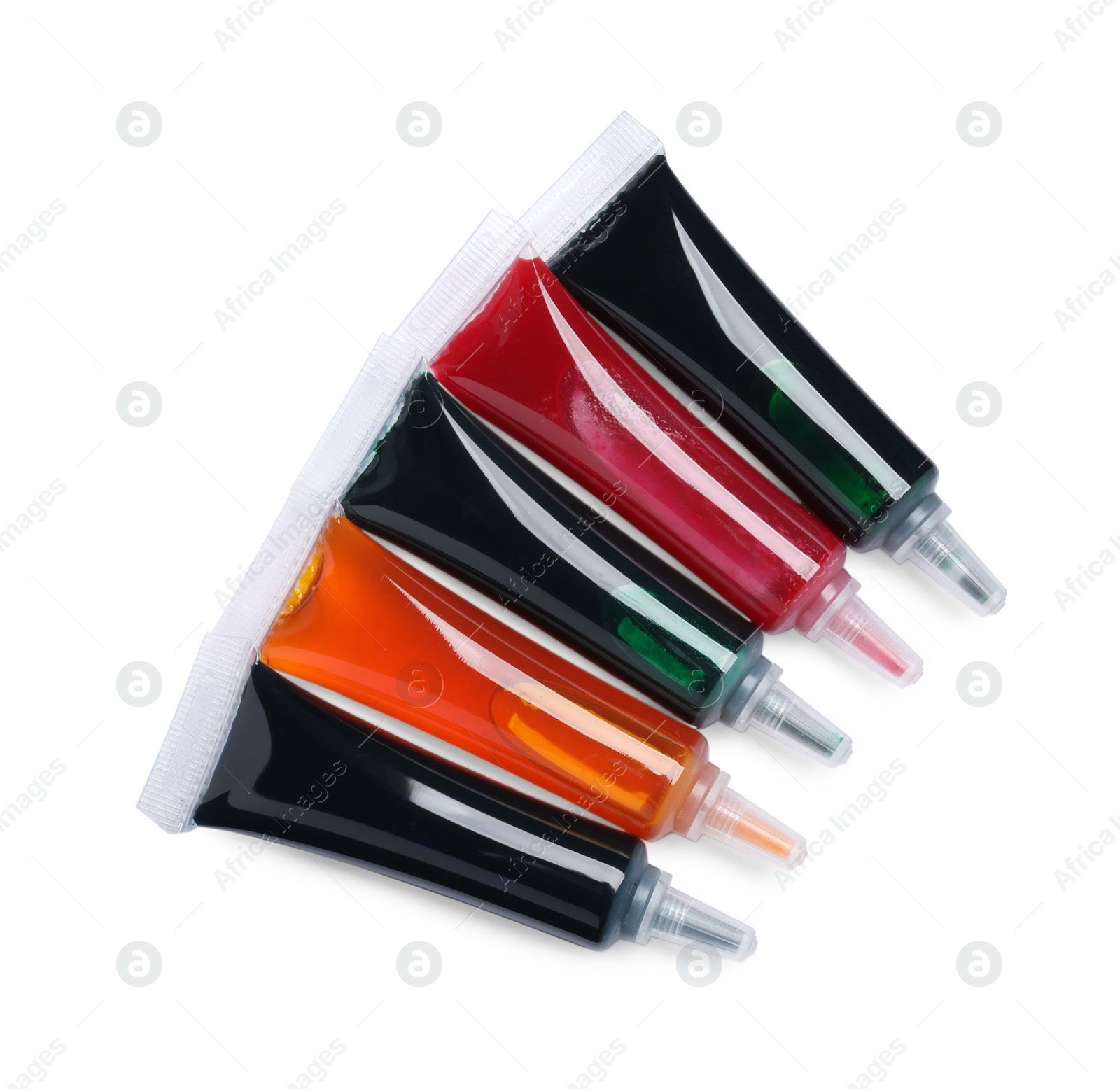 Photo of Tubes with different food coloring on white background, top view