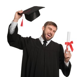 Photo of Emotional student with graduation hat and diploma on white background
