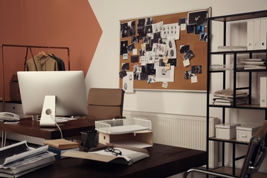 Modern detective office with computer and board