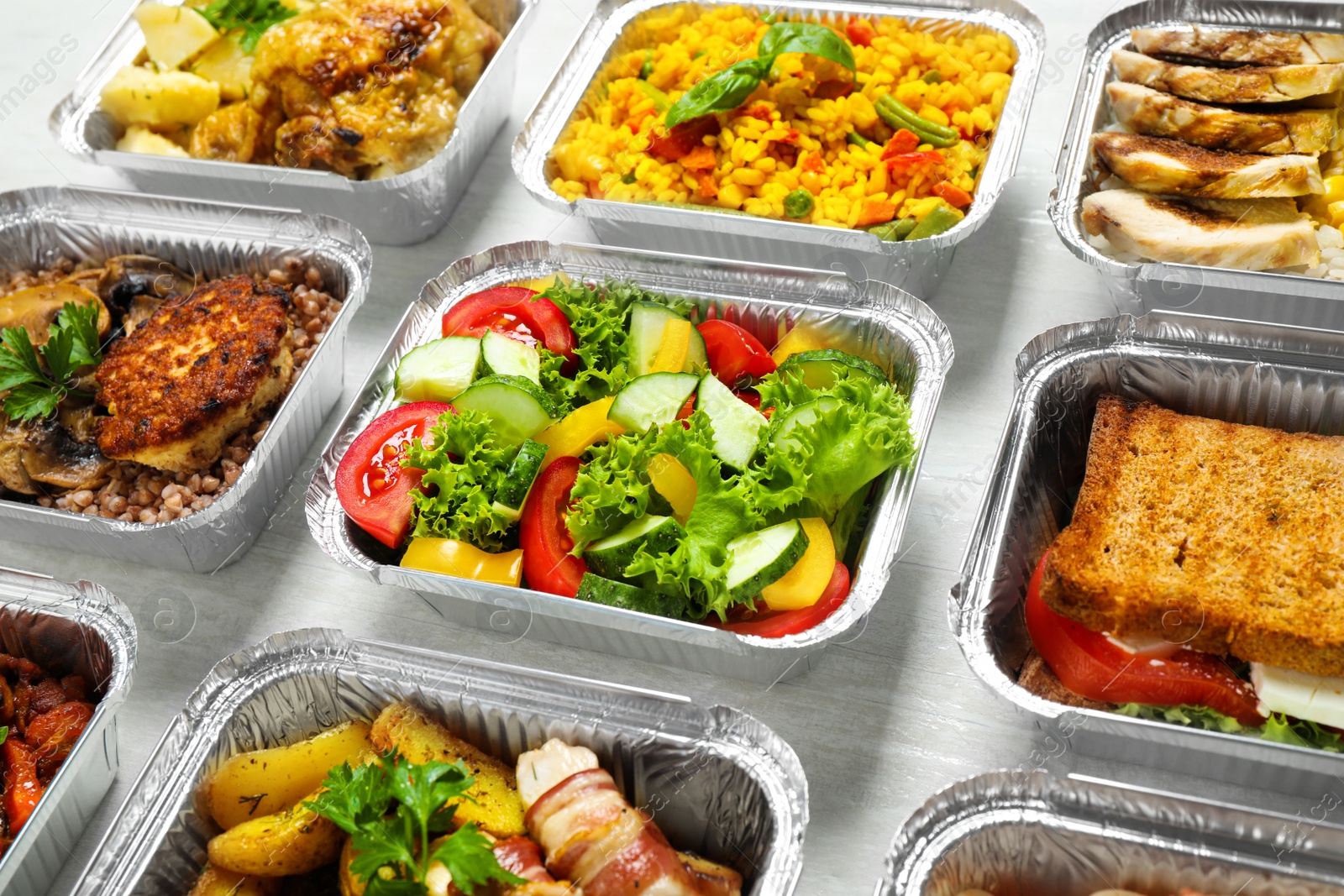 Photo of Lunchboxes on white wooden table. Healthy food delivery