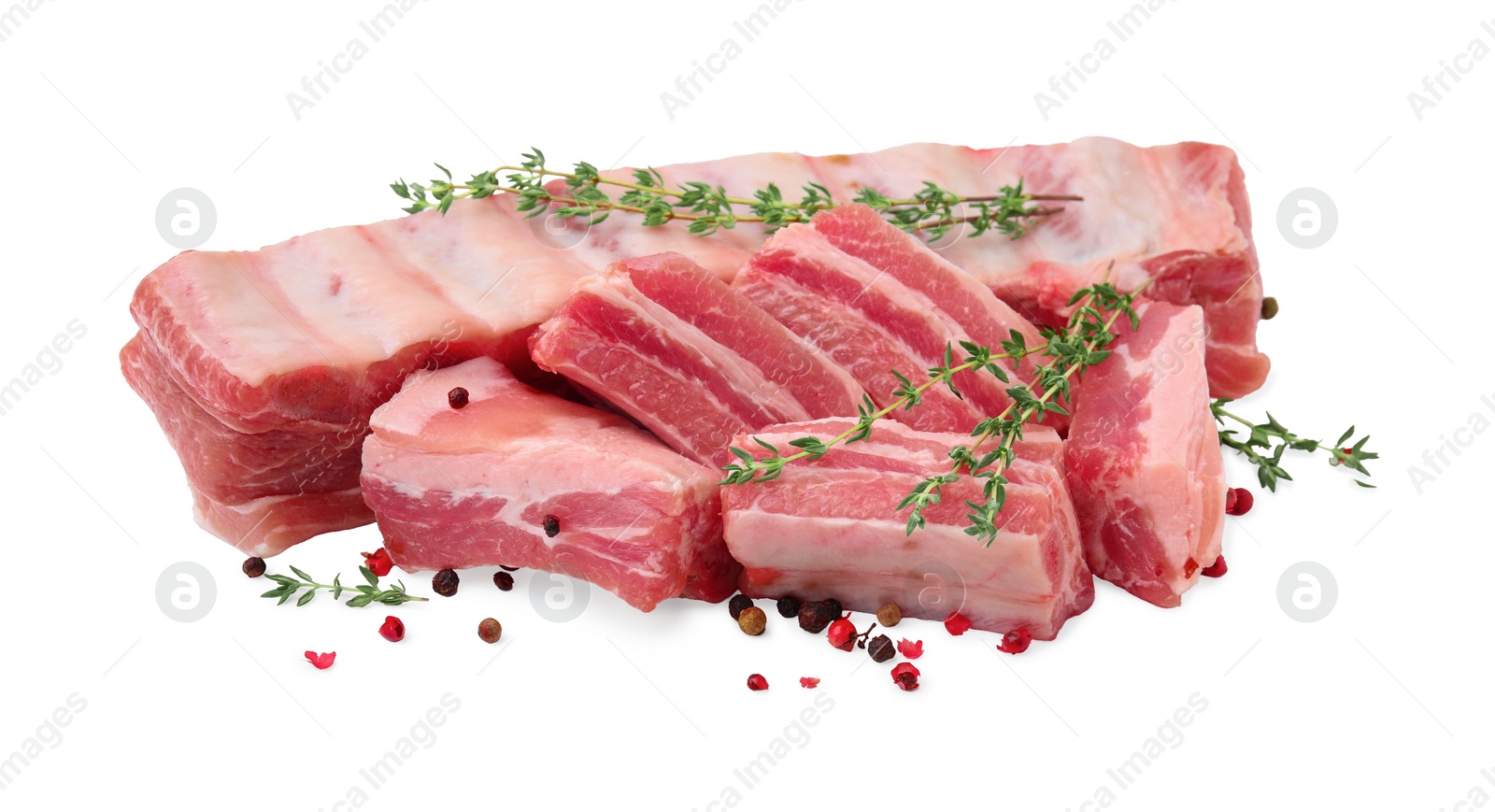 Photo of Fresh raw pork ribs with peppercorns and thyme isolated on white