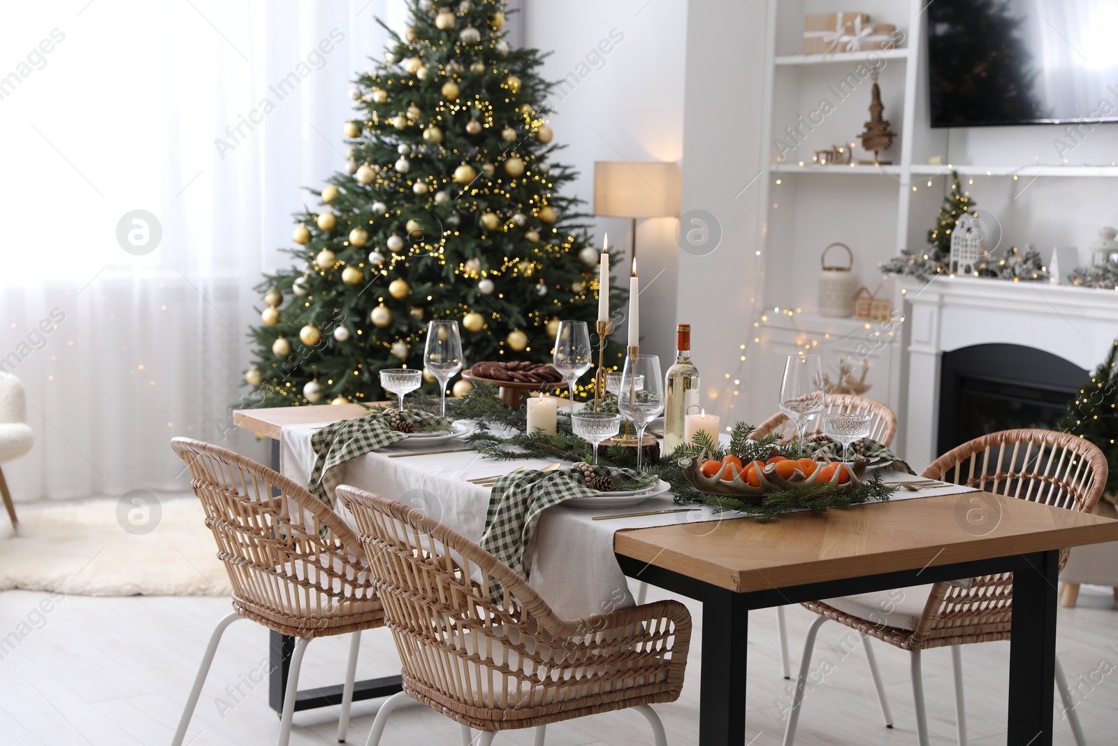 Photo of Christmas table setting with festive decor and dishware in living room