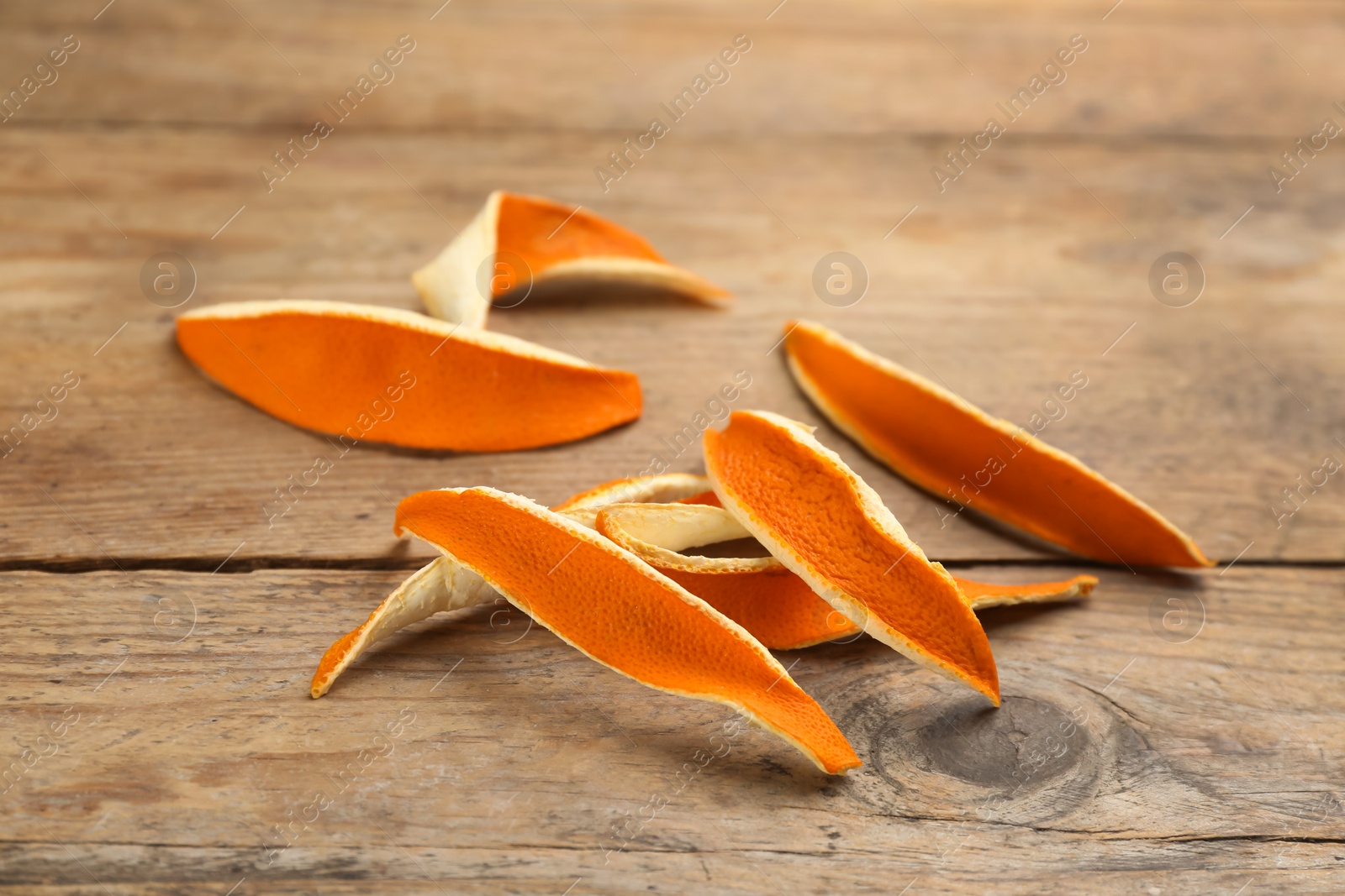 Photo of Pile of dry orange peels on wooden table