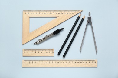 Photo of Flat lay composition with rulers and compasses on light grey background