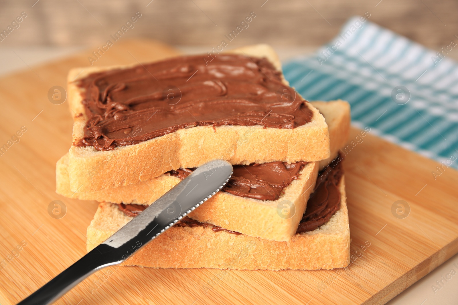 Photo of Tasty toasts with chocolate paste on beige table, closeup. Space for text