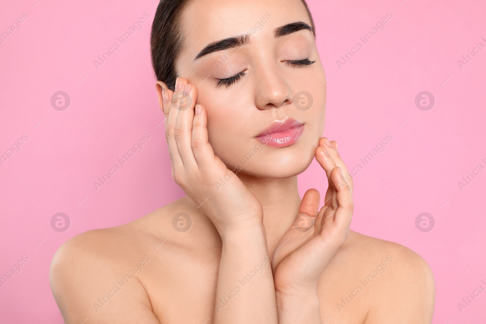 Photo of Portrait of young woman with beautiful face against color background