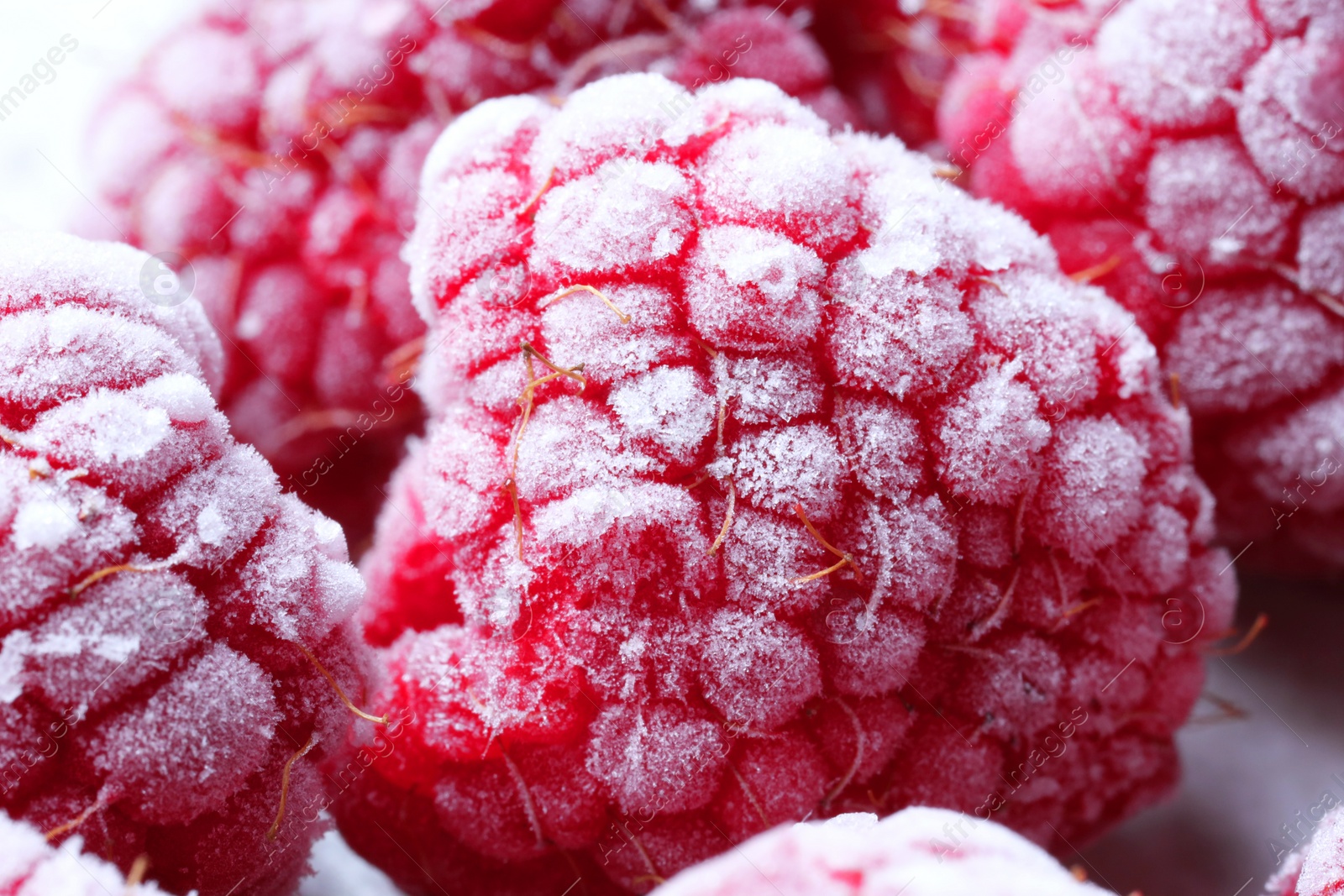 Photo of Many frozen ripe raspberries on table, closeup