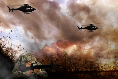 Soldier and helicopters in combat zone. Military service
