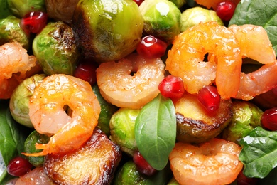 Photo of Delicious warm salad with Brussels sprouts as background, closeup