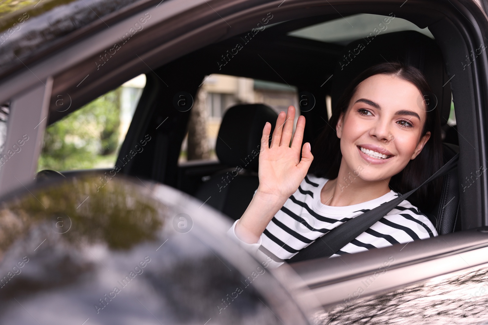 Photo of Woman with safety seat belt driving her modern car