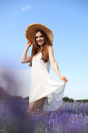 Photo of Young woman in lavender field on summer day