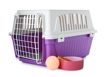 Photo of Violet pet carrier, bowl with treat and toy isolated on white