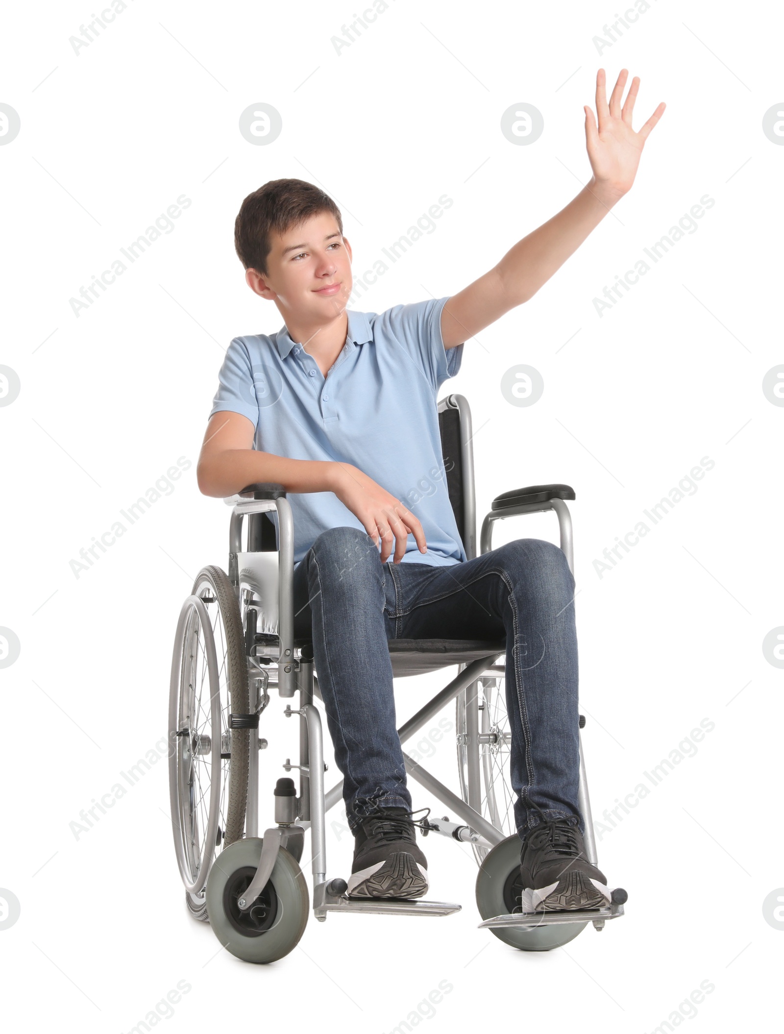 Photo of Teenage boy in wheelchair on white background