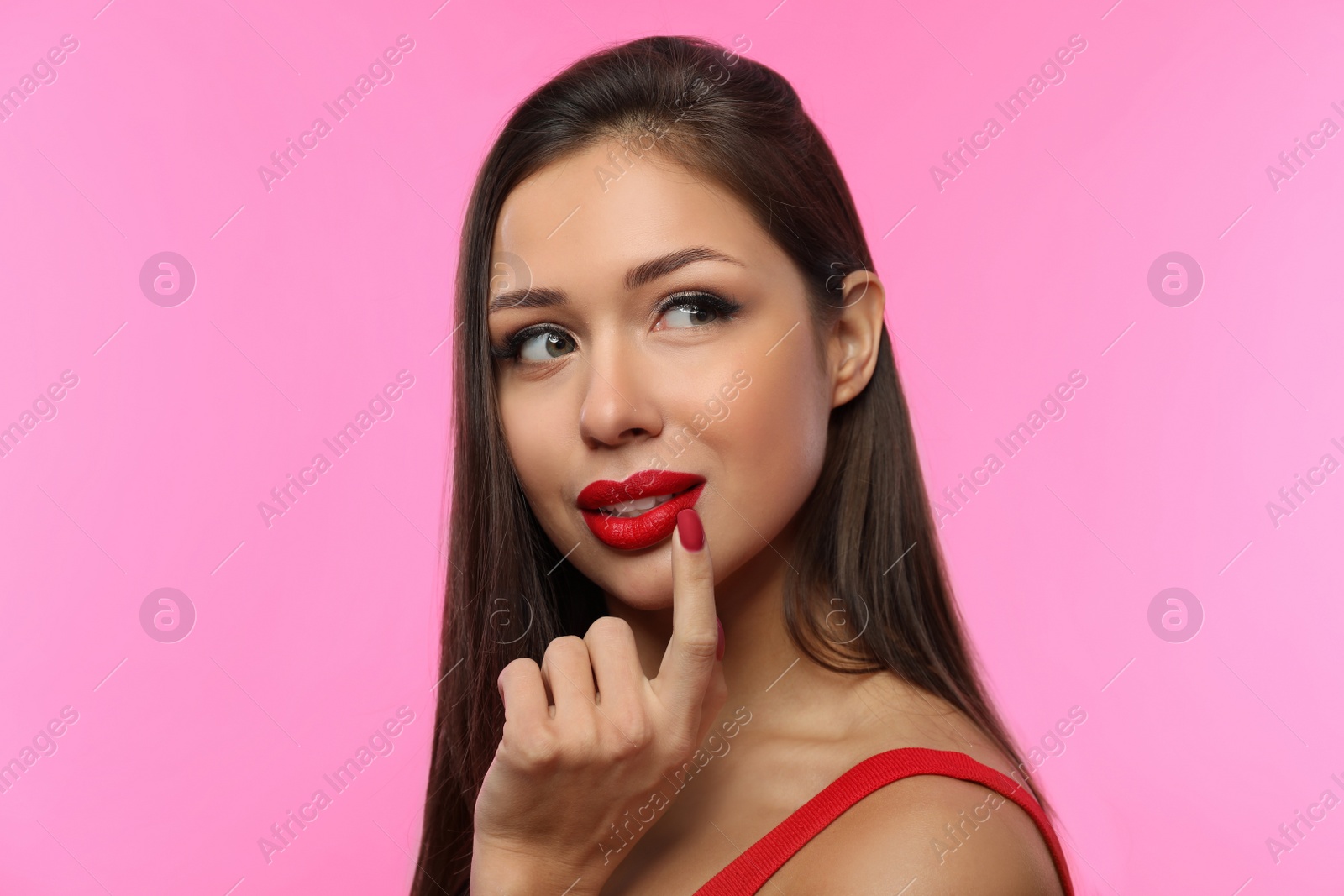 Photo of Beautiful woman with red lipstick on pink background