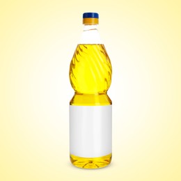 Image of Cooking oil in plastic bottle with empty label on light yellow background. Mockup for design