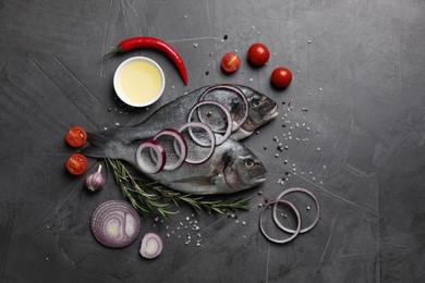 Photo of Fresh dorado fish and ingredients on grey table, flat lay