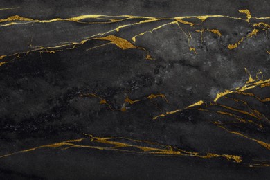 Image of Beautiful black and gold marble surface as background