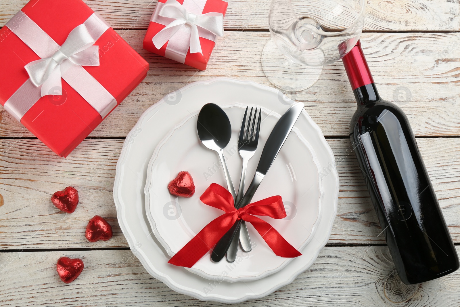 Photo of Beautiful table setting for Valentine's Day dinner on white wooden background, flat lay