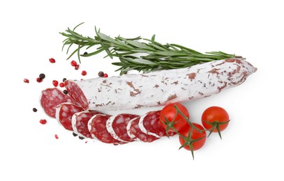 Photo of Delicious cut fuet sausage with rosemary, pepper and tomatoes isolated on white, top view