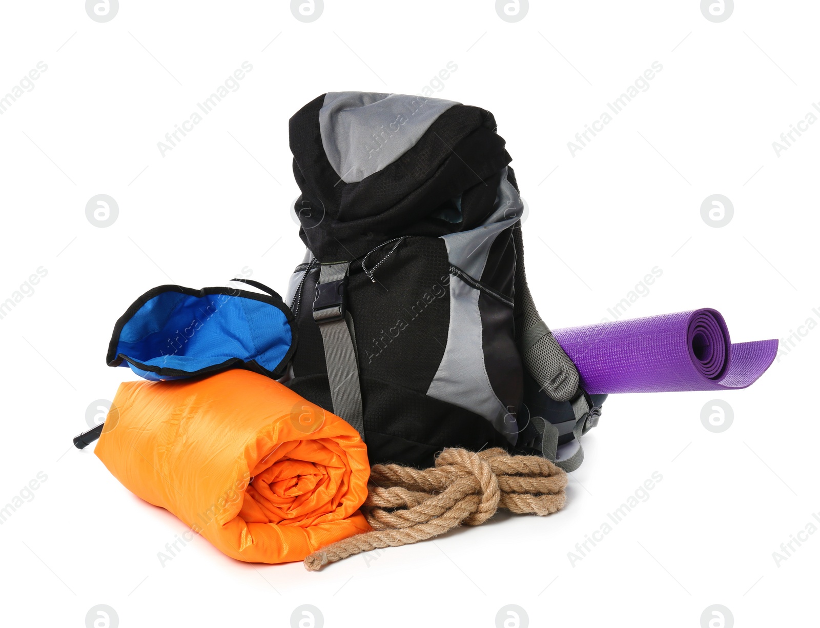 Photo of Sleeping bag, backpack and camping equipment on white background