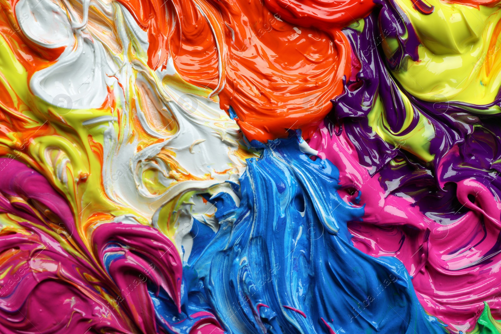 Photo of Mixed colorful acrylic paints as background, closeup view