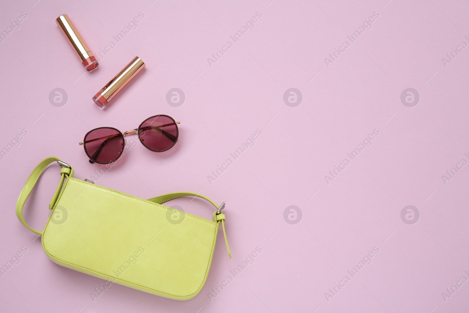 Photo of Flat lay composition with stylish baguette handbag on lilac background. Space for text