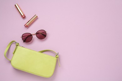 Photo of Flat lay composition with stylish baguette handbag on lilac background. Space for text