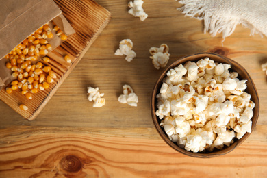 Tasty pop corn on wooden table, flat lay