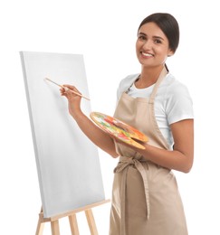 Young woman drawing on easel against white background