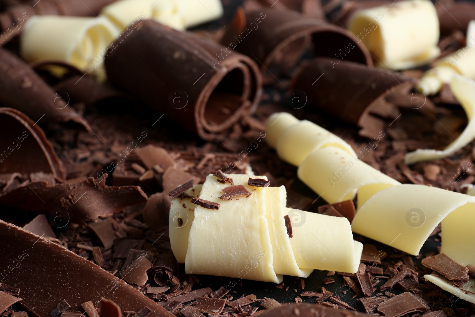 Photo of Yummy chocolate curls for decor as background, closeup