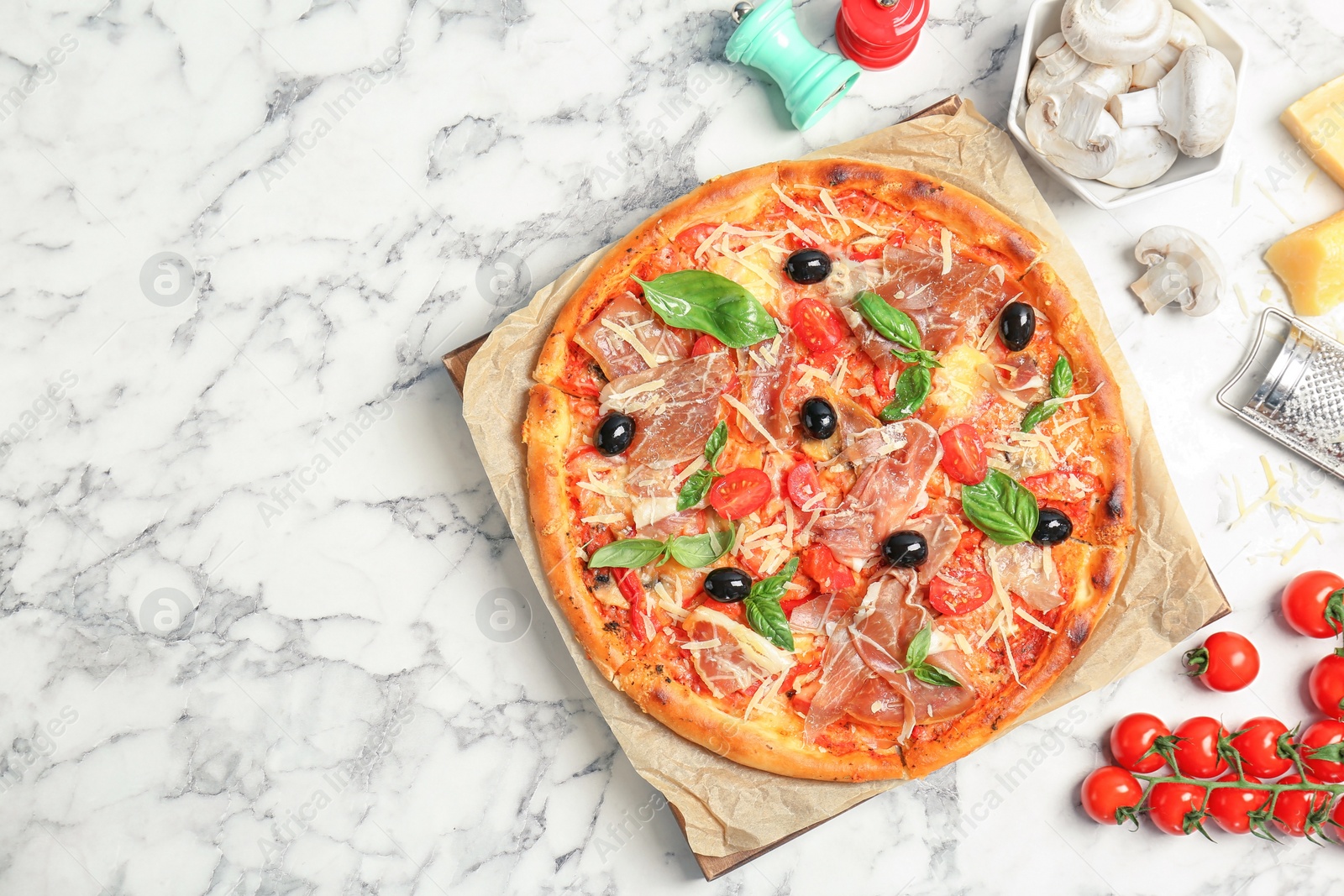 Photo of Flat lay composition with delicious pizza and ingredients on table