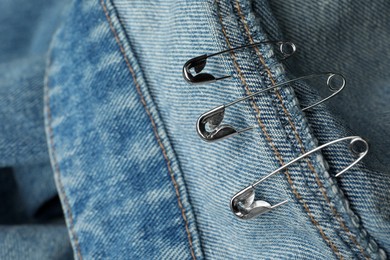Closeup view of metal safety pins on clothing