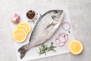 Photo of Flat lay composition with fresh raw dorado fish and ingredients on light grey table