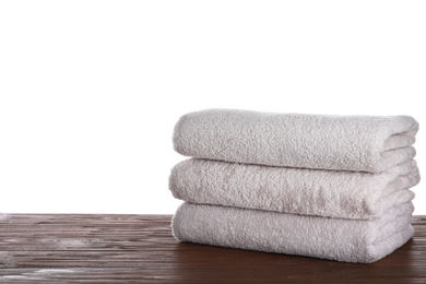 Fresh towels on wooden table against white background. Space for text