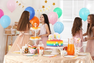 Happy children having fun at birthday party indoors