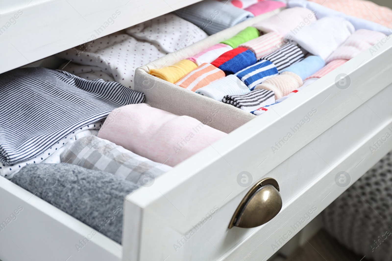 Photo of Wardrobe drawer with many child socks, closeup