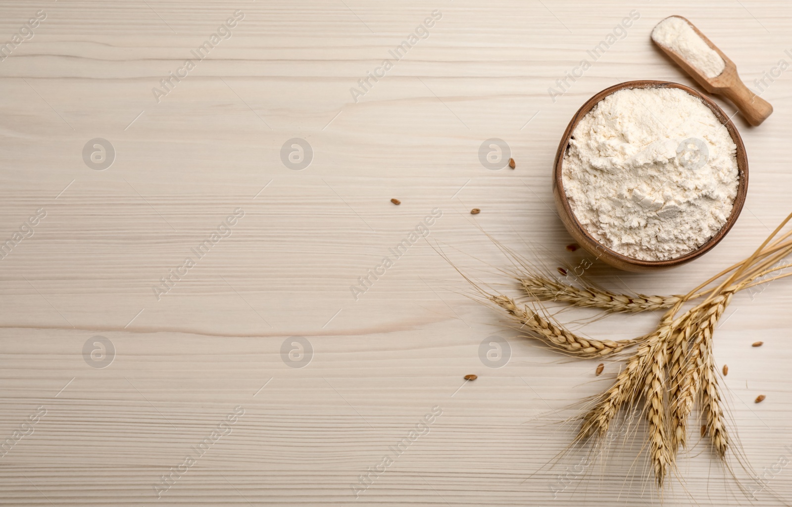 Photo of Flat lay composition with wheat flour on white wooden table. Space for text