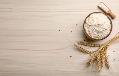 Flat lay composition with wheat flour on white wooden table. Space for text