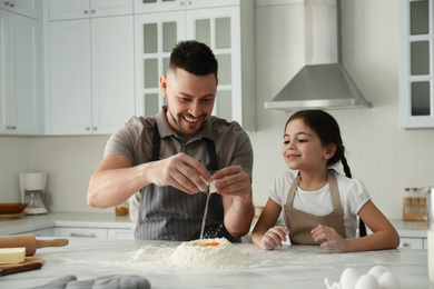 Photo of Father and daughter cooking together in kitchen