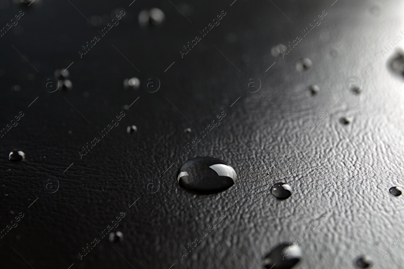 Photo of Many clean water drops on black background