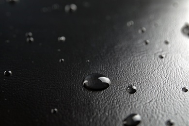 Photo of Many clean water drops on black background