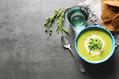 Photo of Flat lay composition with fresh vegetable detox soup made of green peas in dish and space for text on table