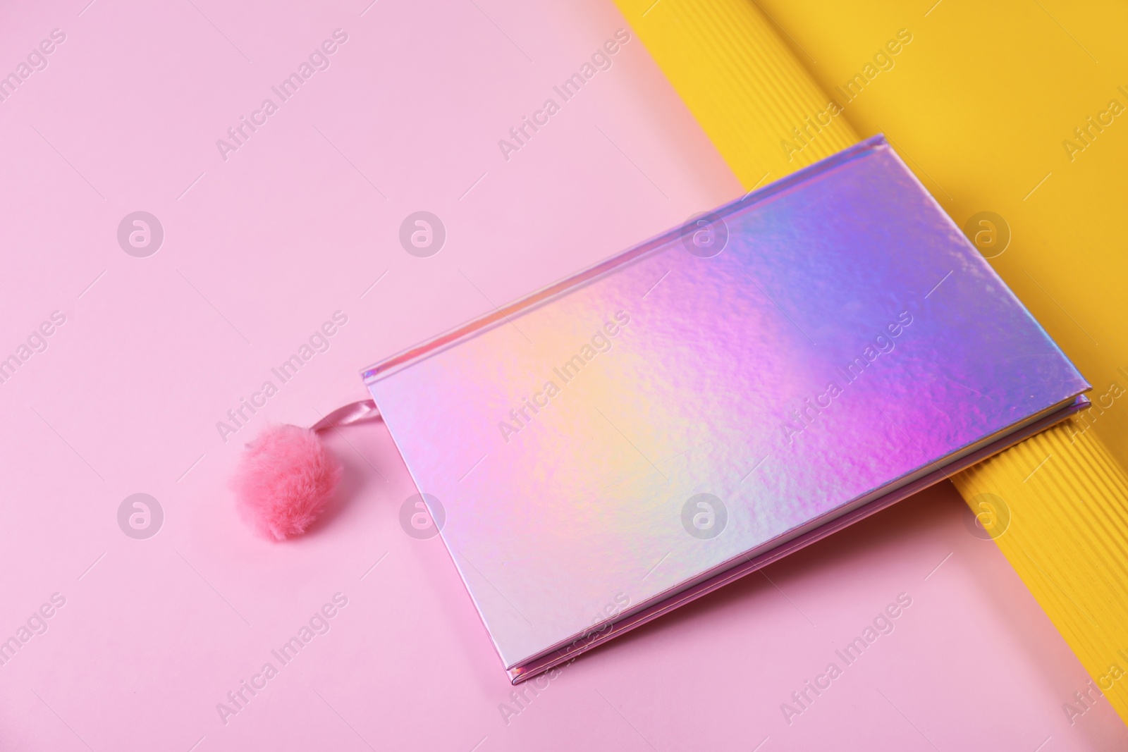 Photo of Beautiful notebook and rolled paper on color background