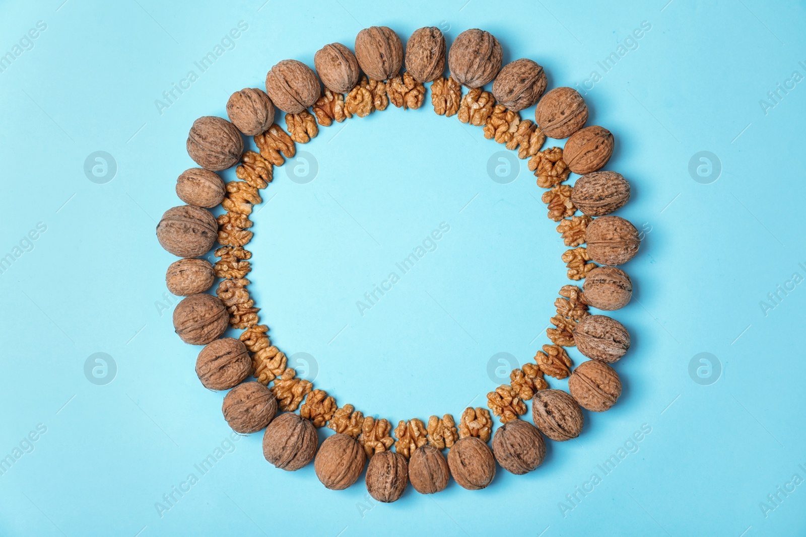 Photo of Flat lay composition with tasty walnuts and space for text on color background