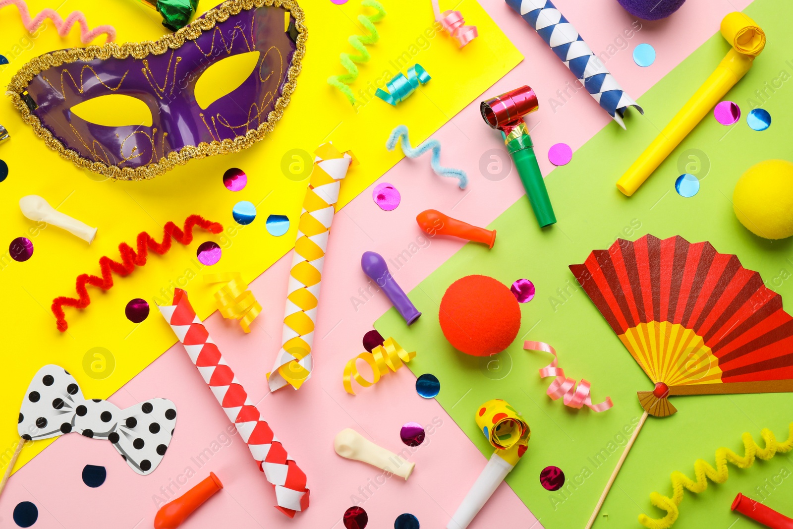 Photo of Flat lay composition with carnival items on color background
