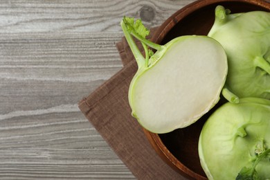 Photo of Whole and cut kohlrabi plants on wooden table, top view