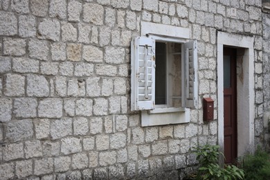 Beautiful old building with stone wall, window and door